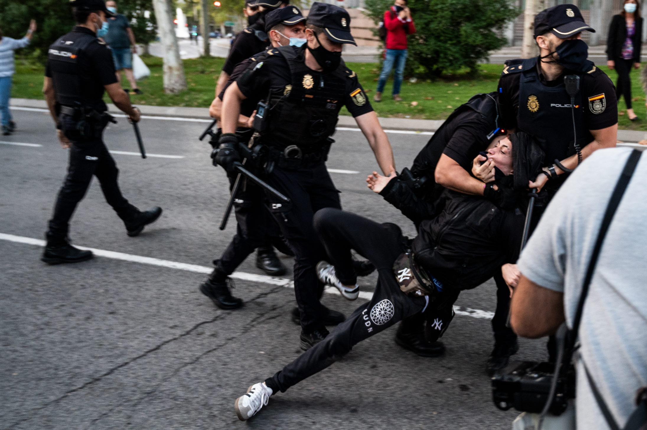 MADRID, SPAIN - 2020/09/24: Police arresting a protester after violent clashes during a protest in Vallecas neighborhood, protesting against the new measures to stop the spread of coronavirus that restrict mobility in 37 areas most affected by the COVID-19, most of them working class areas in the south of Madrid. (Photo by Marcos del Mazo/LightRocket via Getty Images)