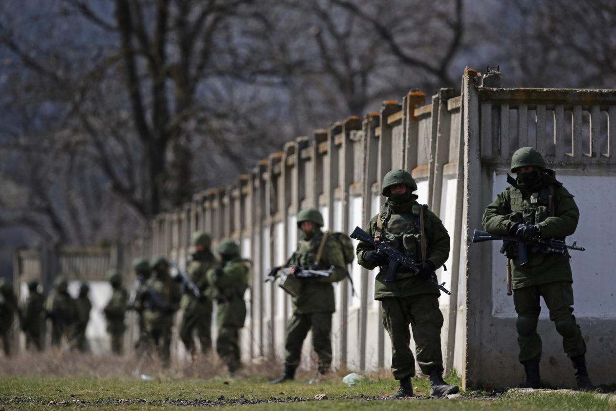 PEREVALNOE, UKRAINE - MARCH 19:  Russian military personnel surround a Ukrainian military base on March 19, 2014 in Perevalnoe, Ukraine. Russia's Constitutional Court ruled unanimously on March 19 that Russia's President Vladimir Putin acted legally by signing a treaty to make Crimea part of Russia.  (Photo by Dan Kitwood/Getty Images)