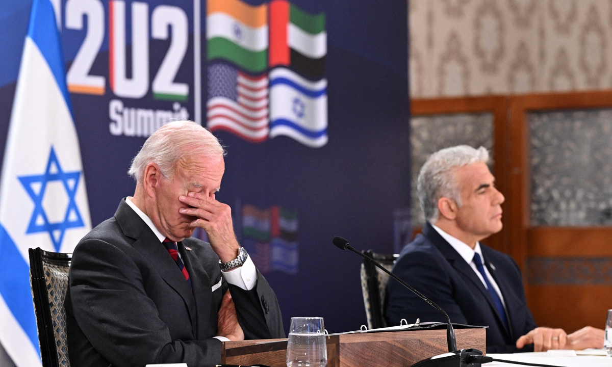 US President Joe Biden (L) and Israel's caretaker Prime Minister Yair Lapid, take part in a virtual meeting with leaders of the I2U2 group, which includes, US, Israel, India, and the United Arab Emirates, at a hotel in Jerusalem, on July 14, 2022. (Photo by MANDEL NGAN / AFP)