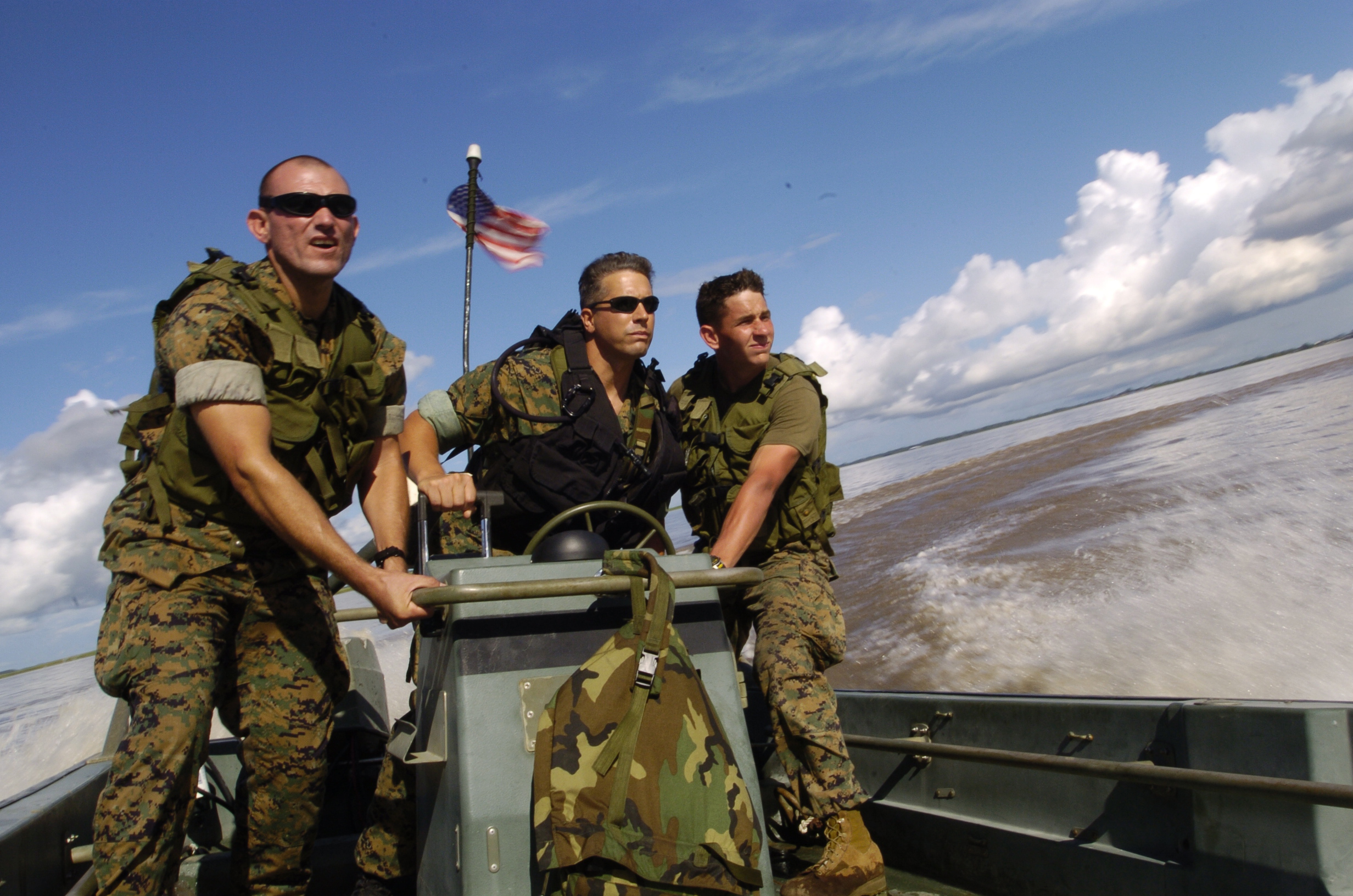 040626-N-1464F-007
Iquitos, Peru (June 26, 2004) - U.S. Marines Staff Sgt. Jose Gutierrez, left, Staff Sgt. Allan Callan, center, and Cpl. David Towers, right, maneuver a Rigid Raider small craft on the Amazon River, during riverine operations with their Latin American counterparts, while preparing for beach assault exercises during UNITAS 45-04. Eleven partner nations from the U.S. and Latin America are supporting the largest multilateral exercise in the Southern Hemisphere. Held Since 1959, UNITAS aims to unite military forces throughout the Americas with bilateral and multilateral shipboard, amphibious and in-port exercises and operations. UNITAS improves operational readiness and interoperability of U.S. and South American naval, coast guard, and marine forces while promoting friendship, professionalism and understanding among participants. U.S. Navy photo by Chief Journalist Dave Fliesen (RELEASED)